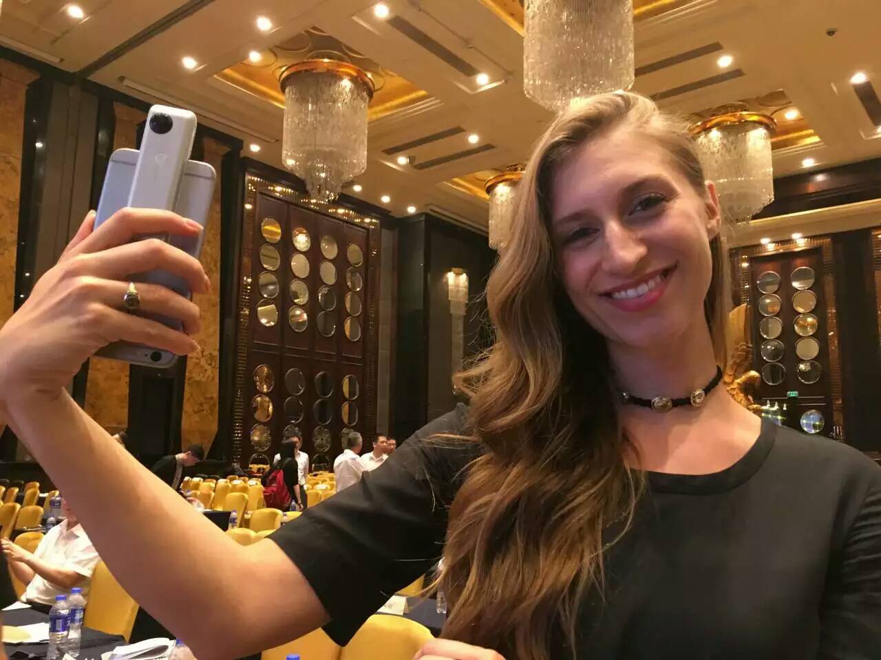 Woman posing with Insta360 Nano on Iphone