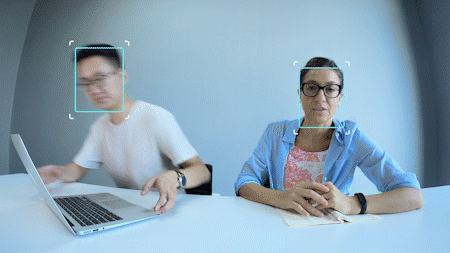 Auto zoom gif shows the webcam focused on two people, then one leaves and the camera refocuses just on the remaining person