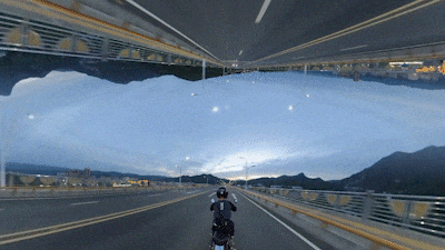 A gif showing the "Horizon Flip" Shot Lab effect with a person driving a scooter. 