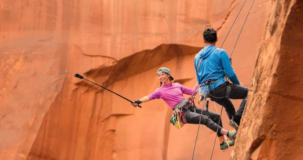 Insta360 ONE RS 1-Inch 360 Edition on selfie stick while climbing