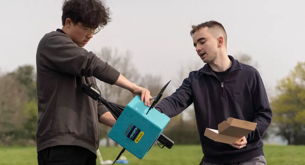 Two students working to set up the Karman Space Programme balloon test, featuring X3