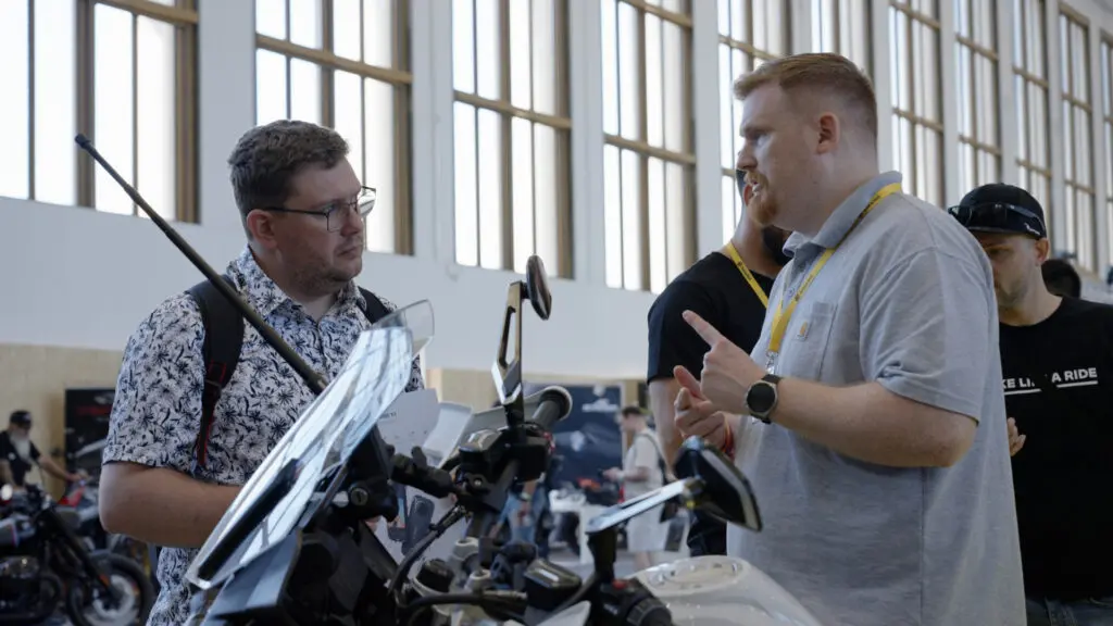 An Insta360 staff member chats to an attendee at the Berlin BMW Motorrad event.