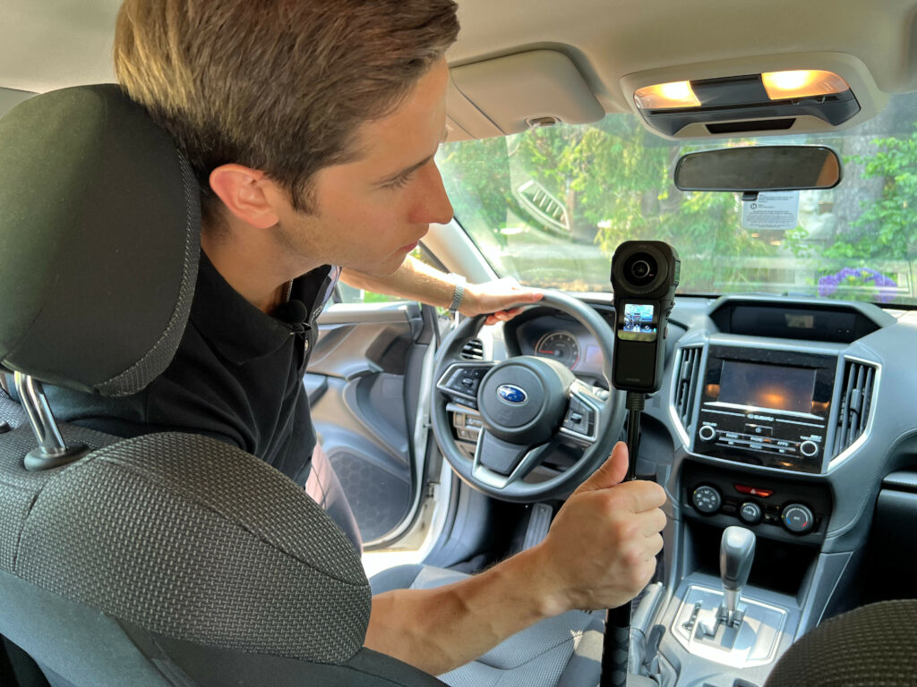 A Glo3D staff member prepares to film a car interior with Insta360 RS 1-Inch 360 Edition