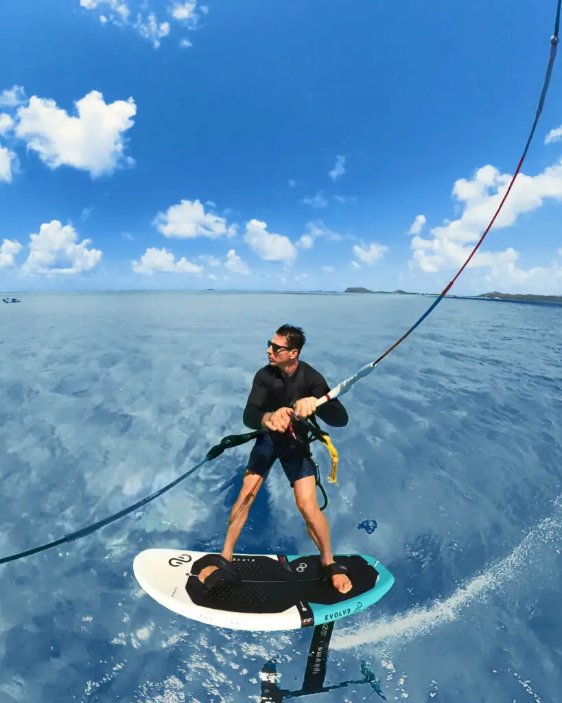 A man on a kitesurfing board in the middle of the sea, shot with the Insta360 X3 Water Sports Rope Mount