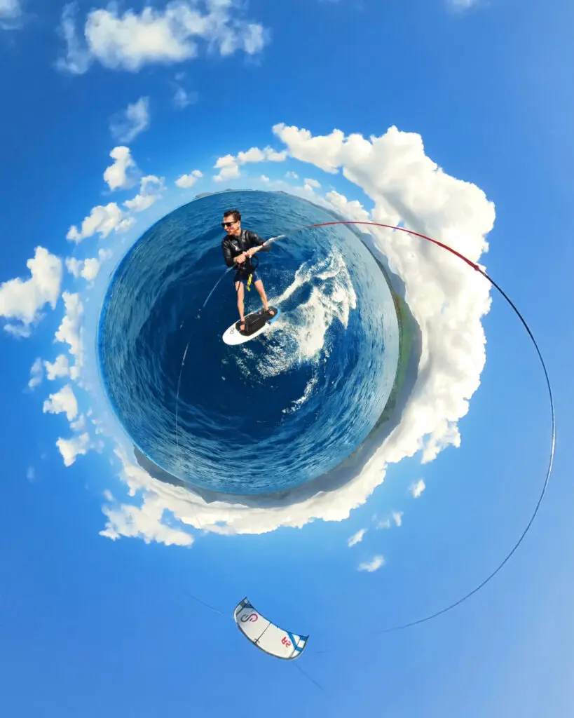 A man on a kitesurfing board in the middle of the sea, shot with the Insta360 X3 Water Sports Rope Mount