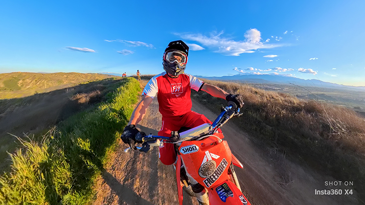 A dirt bike rider using Insta360 X4 for capture.