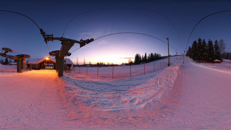 Equirectangular image at the bottom of a ski life at sunset