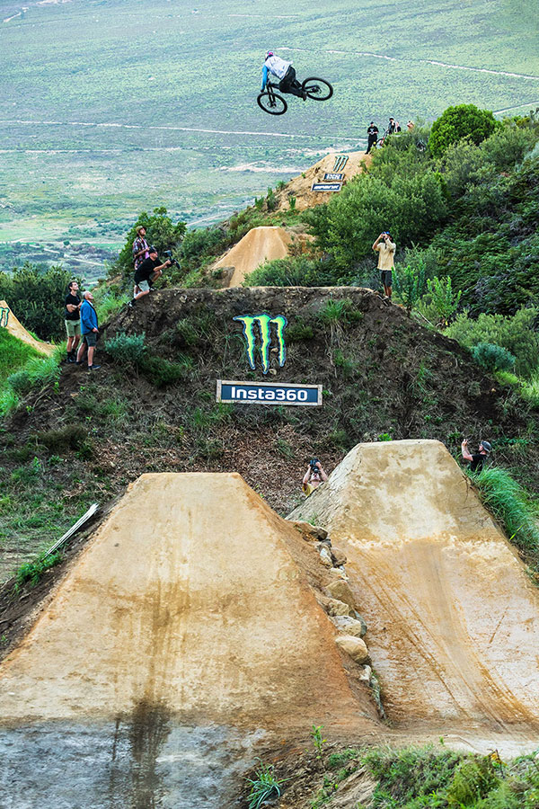 A rider going full send over a massive jump at Darkfest 2025 in Stellenbosch.
