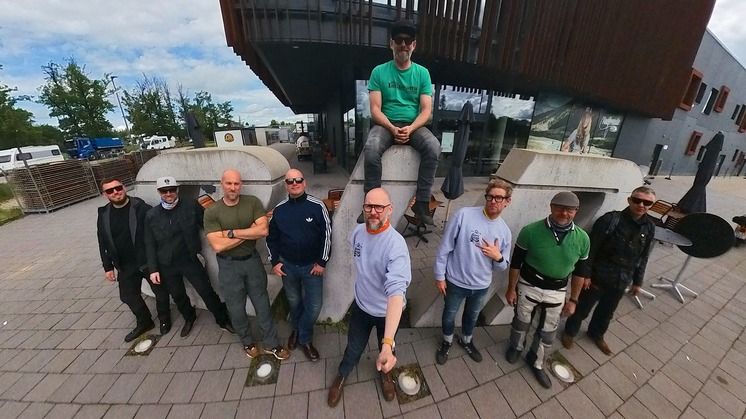 A group of men posing and taking a selfie.