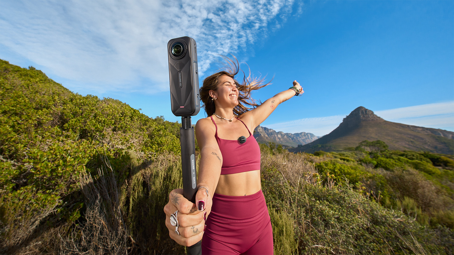 Woman using Insta360 Mic Air with Insta360 X5 for vlogging.