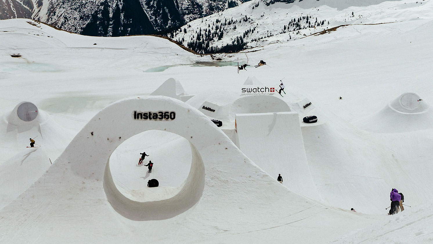 Professional skiers shredding the slopes at the 2025 Swatch Nines event in Schiltorn.