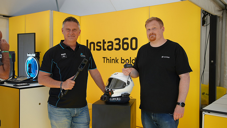 Cardo and Insta360 employees pictured at a booth.