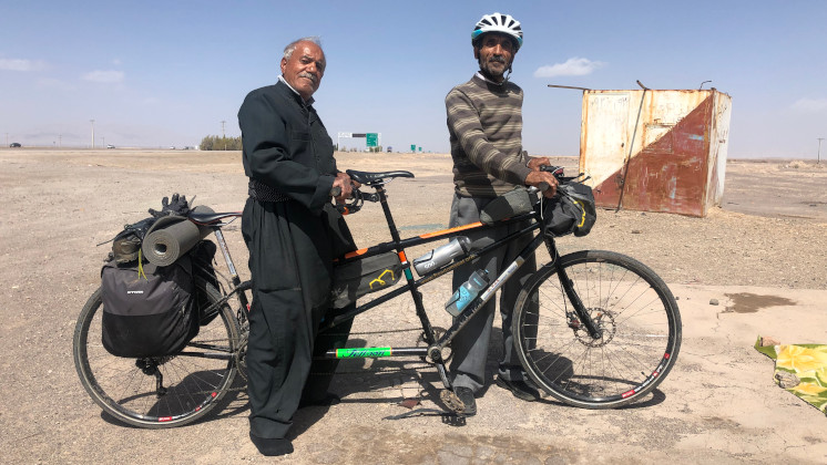 Two men with Kumar's tandem bike.