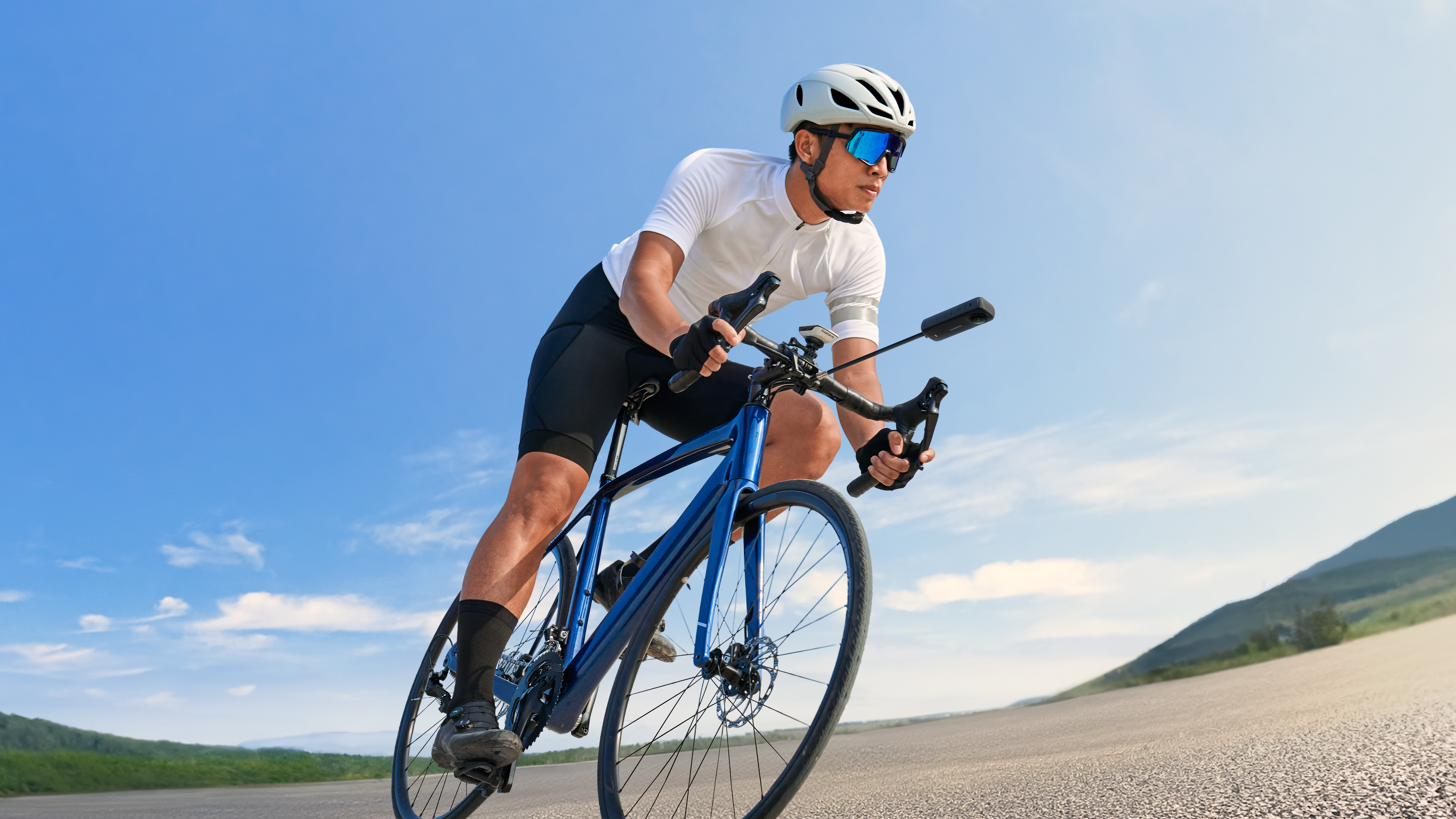 A man cycling with Insta360 X4 attached to his bike with the Third Person Bike Handlebar Mount.