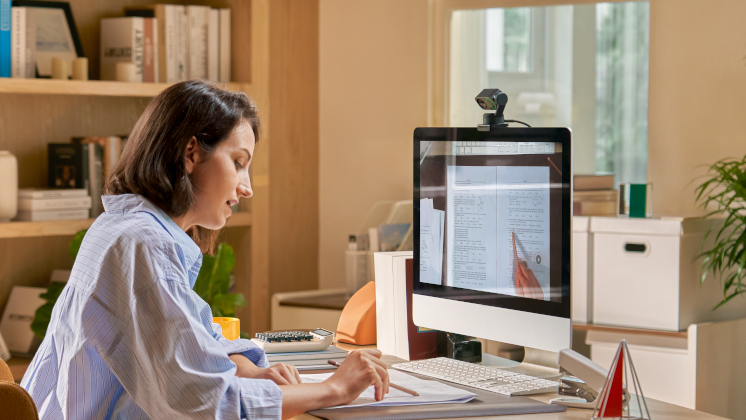 A woman using Link 2C at a desk while working from home.