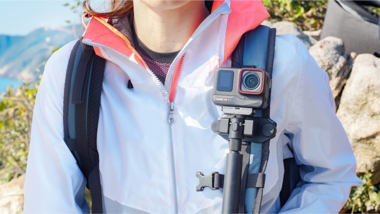 This image shows how The Magnetic Selfie Stick Holster can be attached to your backpack strap for quick access to your camera and selfie stick.