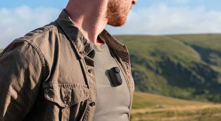 A tiny camera is held on one man's chest.