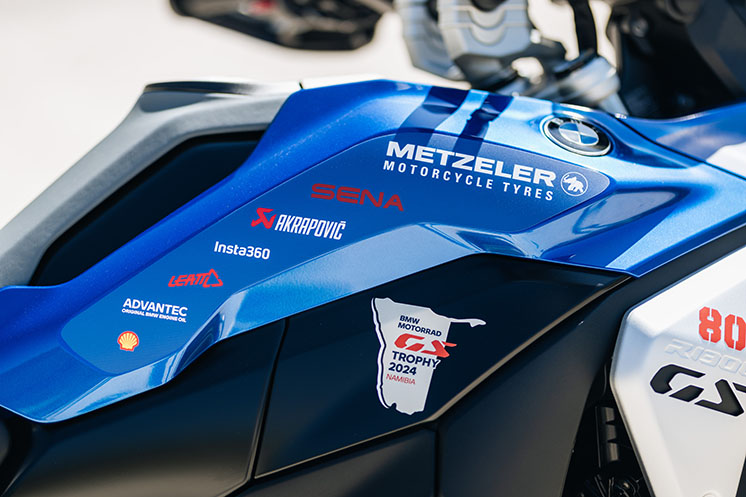 A close up of a BMW bike with sponsors.