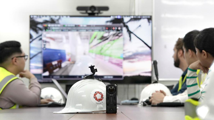 Evercam employees holding a meeting with Insta360 X5 displayed in the foreground.