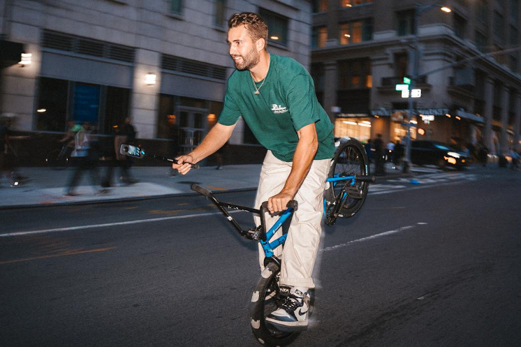 Billy Perry doing BMX tricks on the streets of NYC while holding Insta360 X3