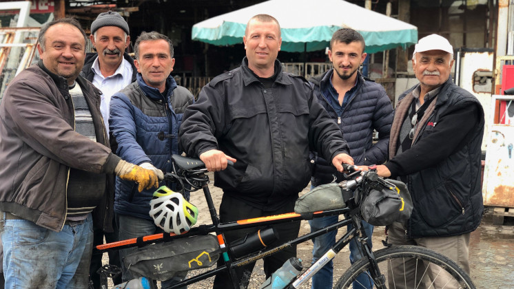 A group of men with Kumar's tandem bike.