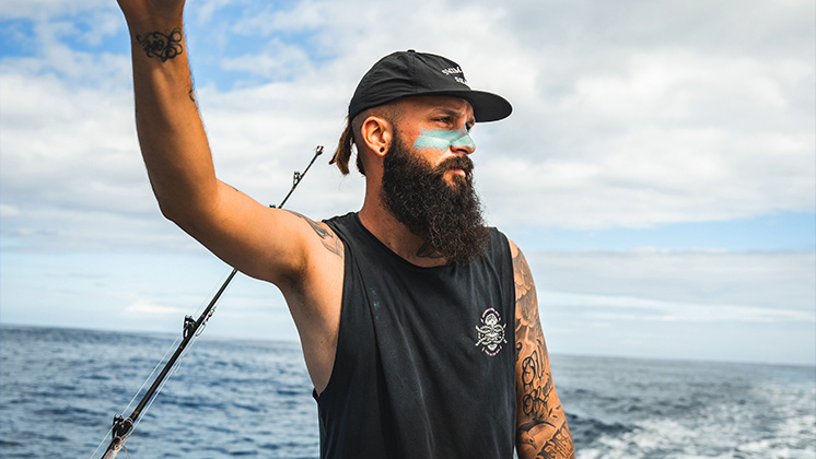 Side portrait of Zimy on board a boat with the sea in the background