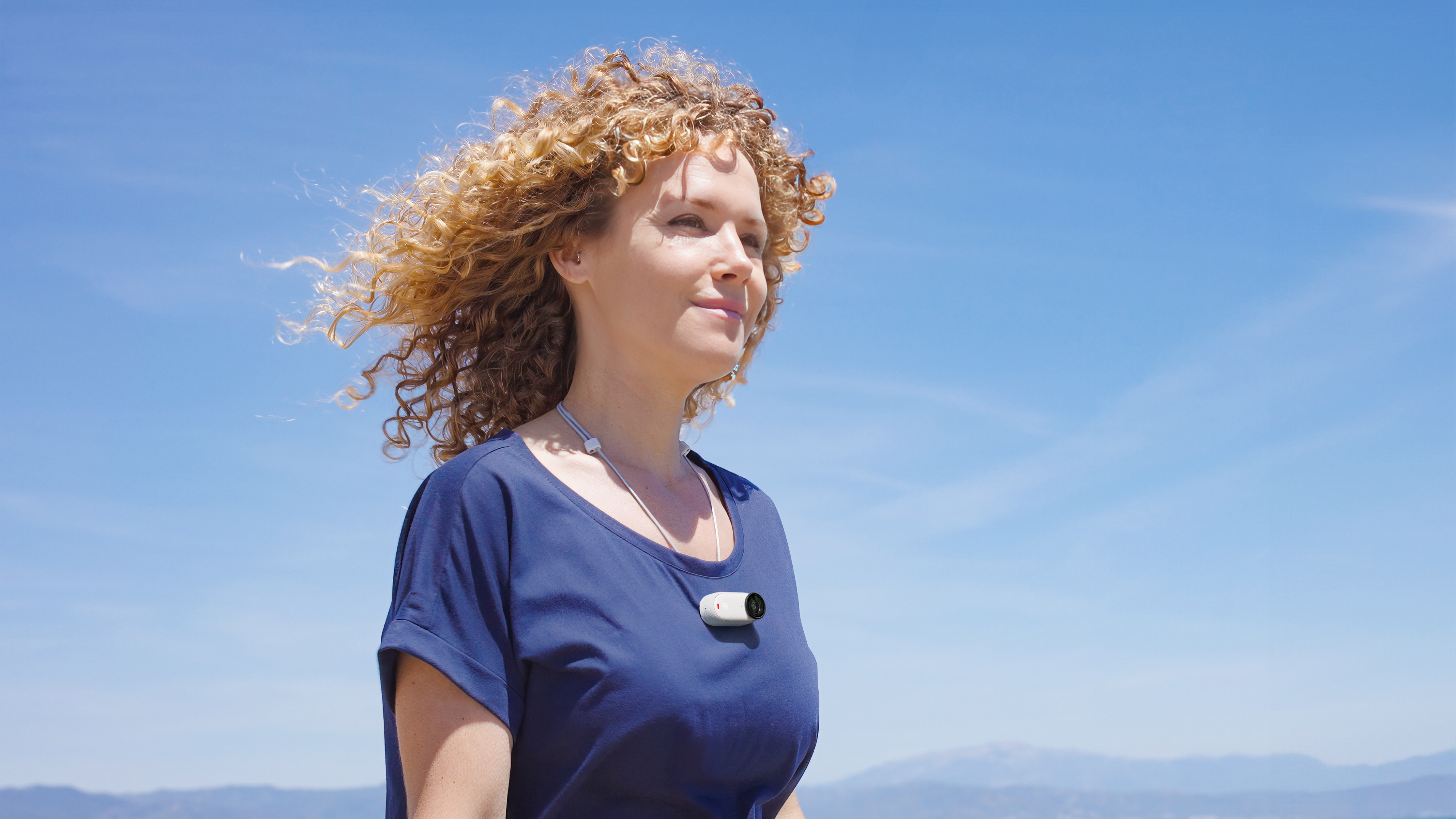 A show of a woman using GO 3S with the Magnet Pendant accessory.