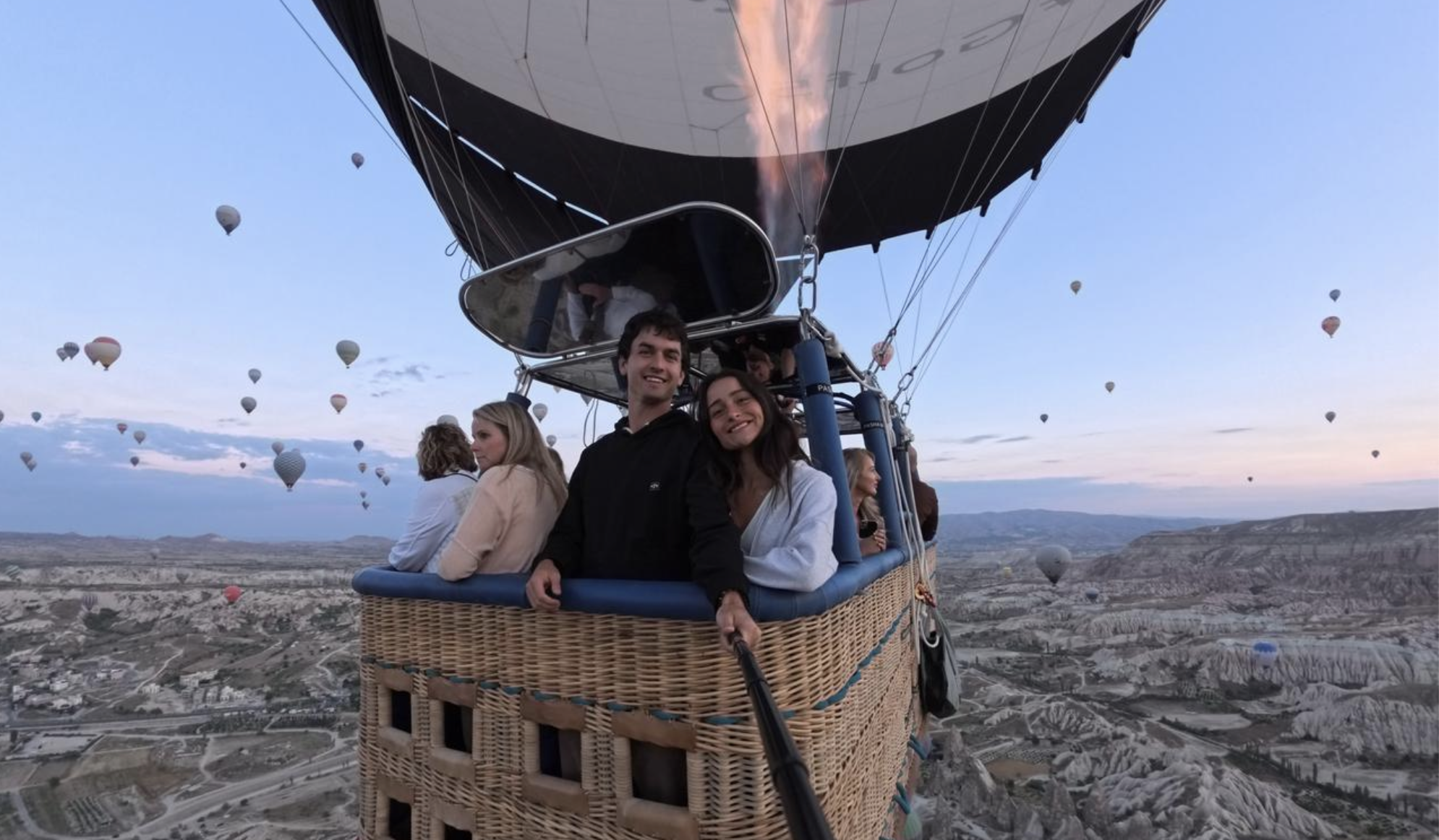 Couple filming hot air balloon ride with Insta360 ace pro 2on selfie stick