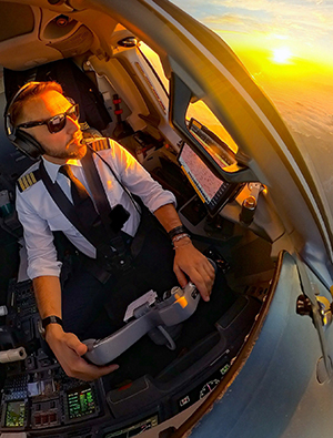 A pilot looks into a sunset, captured on an Insta360 camera.