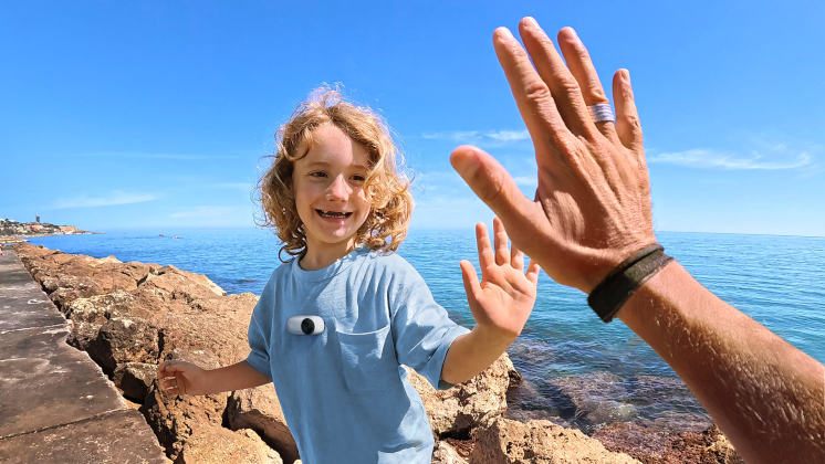 A man is about to give a kid a high five.