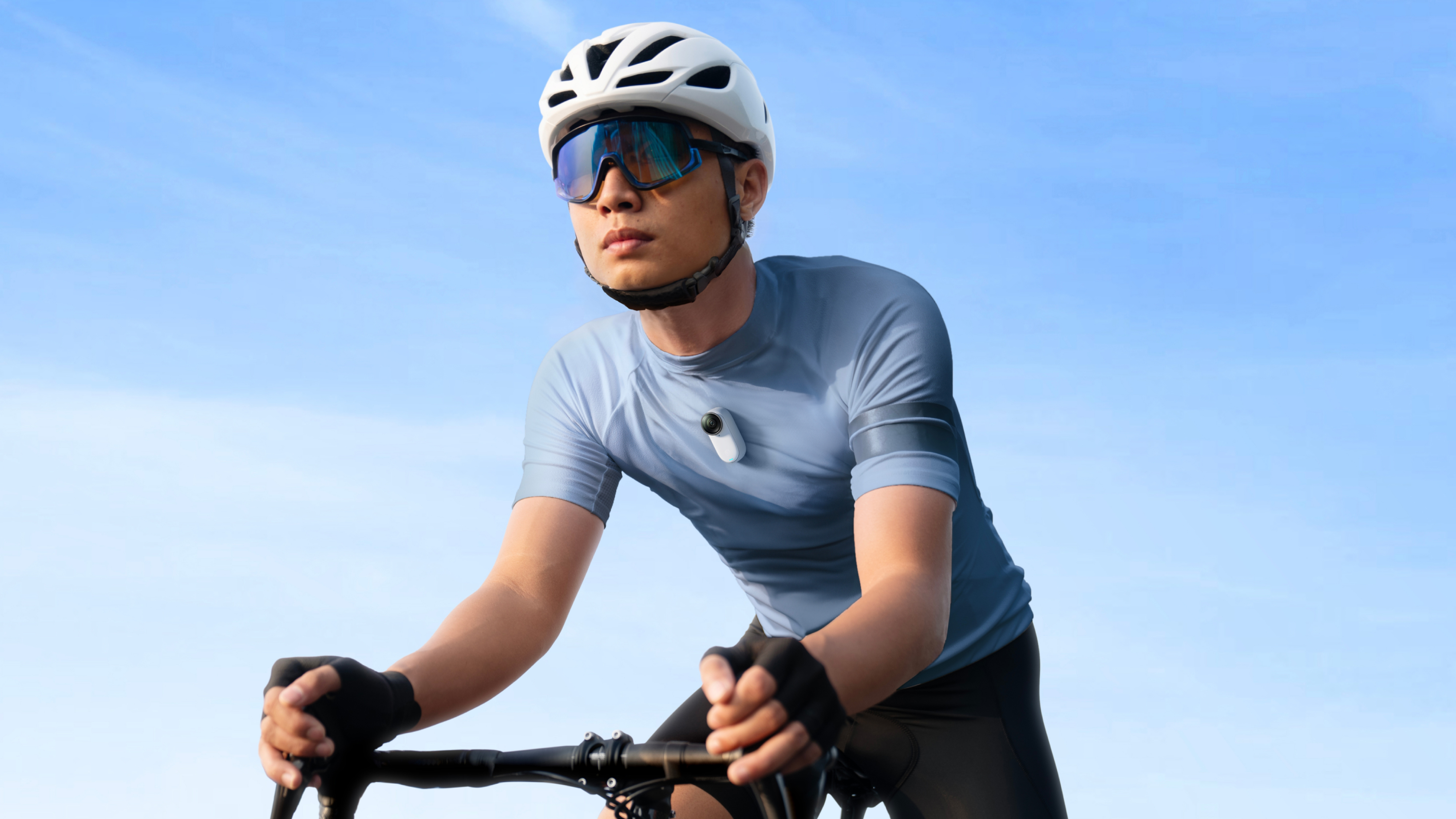 A man cycling with Insta360 GO 3S attached with the Magnet Pendant.
