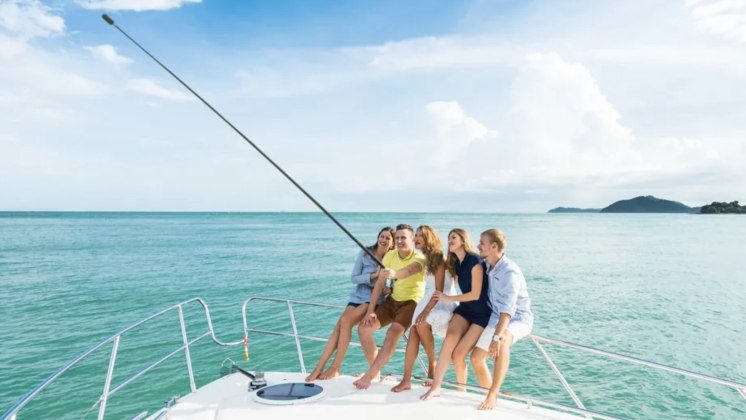 A group of people using the Extended Selfie Stick with Insta360 X4.