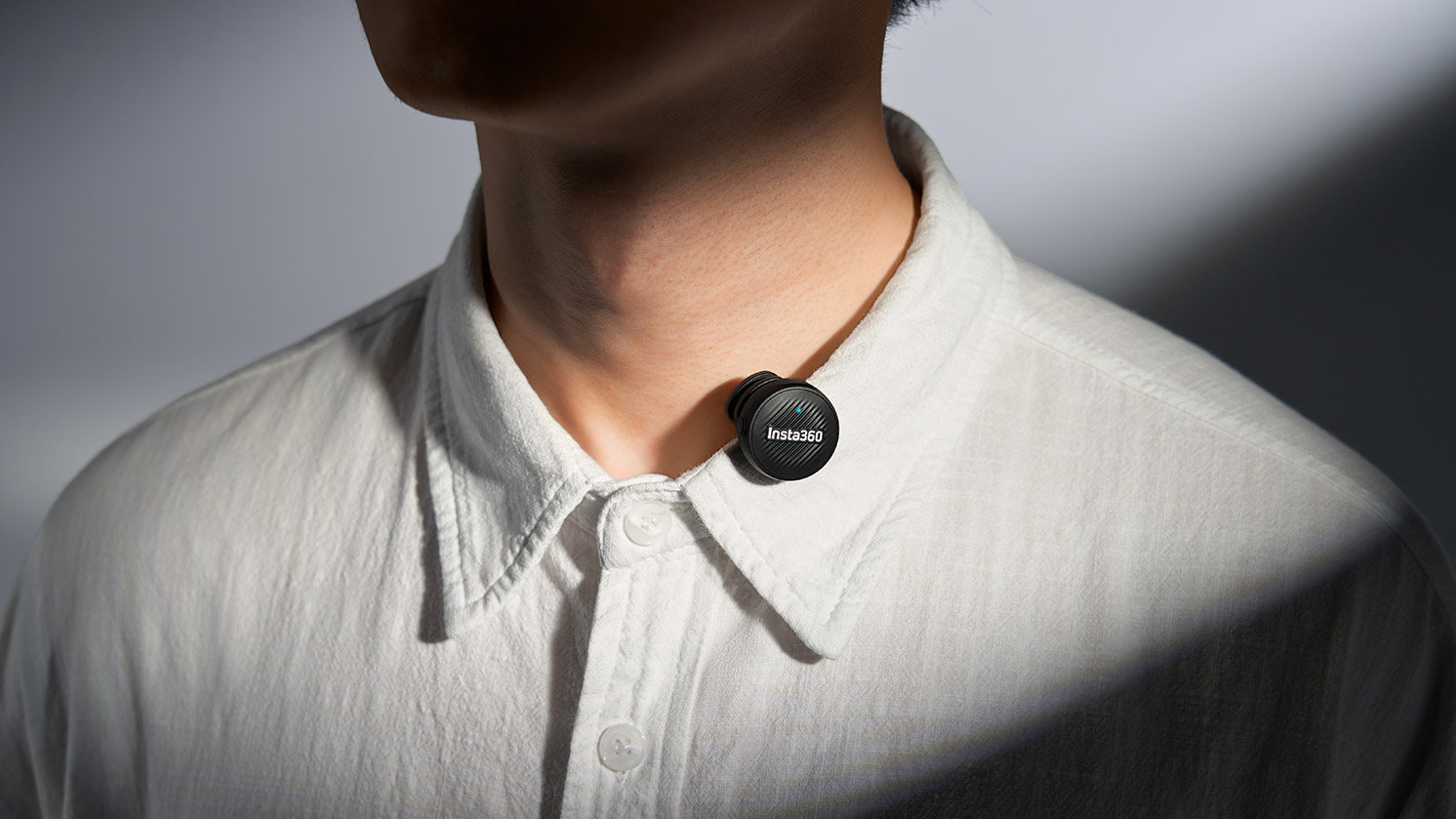 Insta360 Mic Air clipped to the collar of a shirt, showcasing the versatile mounting options.